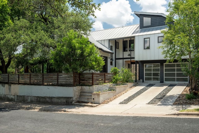 913 Christopher St, Austin, TX 78704 - view of front of home featuring a metal roof, a standing seam roof, a balcony, and driveway