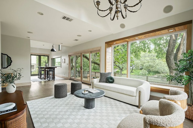 913 Christopher St, Austin, TX 78704 - living room featuring a chandelier, wood finished floors, lofted ceiling, and recessed lighting