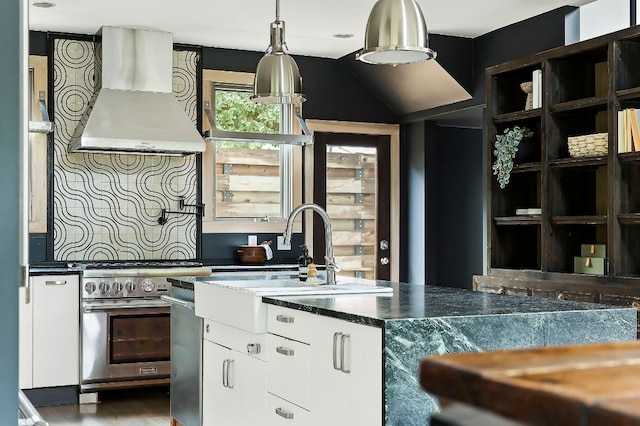 913 Christopher St, Austin, TX 78704 - kitchen with stainless steel appliances, custom exhaust hood, white cabinets, and dark countertops