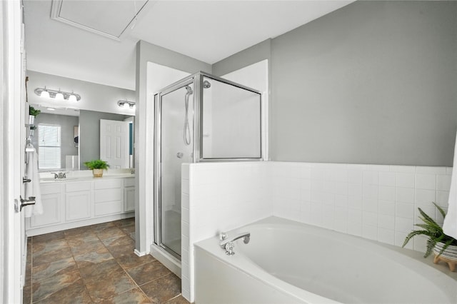 12007 Sky W Dr, Austin, TX 78758 - full bathroom featuring a garden tub, vanity, a stall shower, and stone finish floors