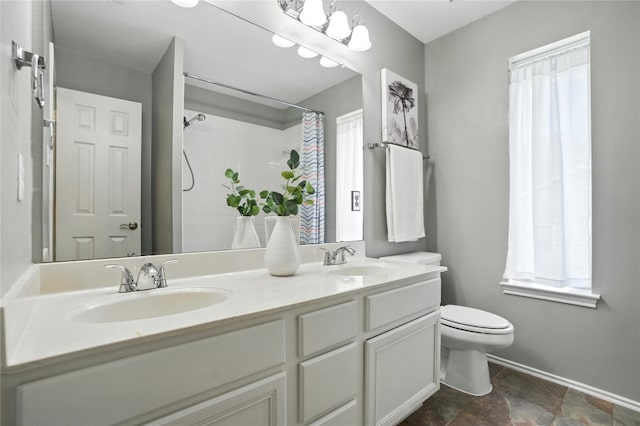 12007 Sky W Dr, Austin, TX 78758 - bathroom featuring double vanity, a shower with shower curtain, and stone finish floors