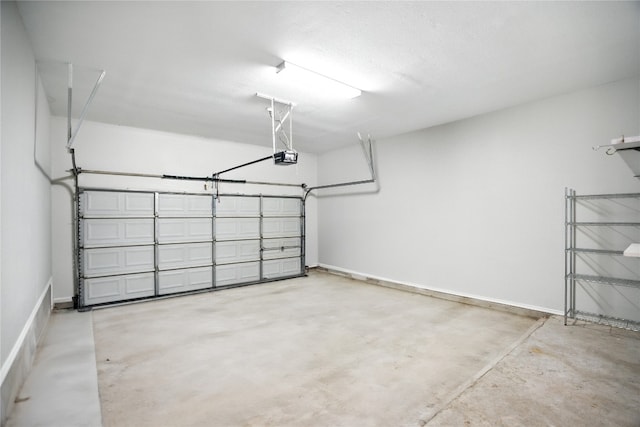 12007 Sky W Dr, Austin, TX 78758 - garage with a garage door opener and baseboards