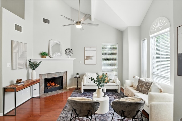 12007 Sky W Dr, Austin, TX 78758 - living area with wood finished floors, a tile fireplace, ceiling fan, and high vaulted ceiling