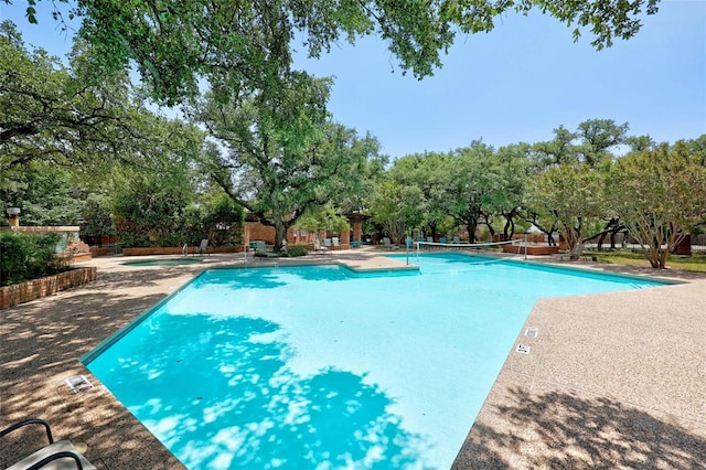 12007 Sky W Dr, Austin, TX 78758 - community pool featuring view of wooded area and a patio