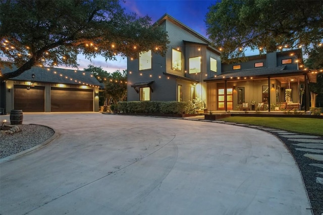 11420 Rim Rock Trl, Austin, TX 78737 - contemporary home featuring covered porch, board and batten siding, driveway, and a detached garage