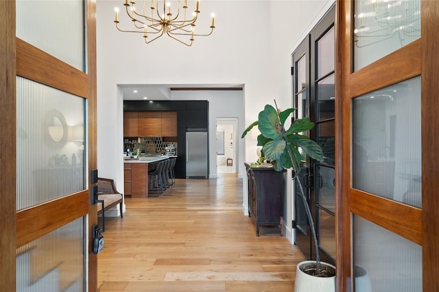 11420 Rim Rock Trl, Austin, TX 78737 - entrance foyer with a high ceiling, a chandelier, and light wood-style flooring
