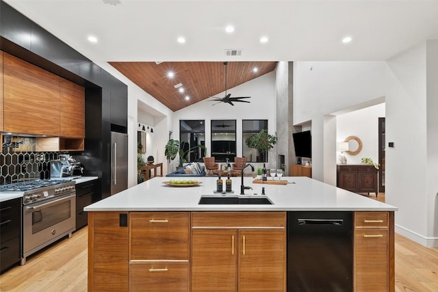 11420 Rim Rock Trl, Austin, TX 78737 - kitchen featuring high end range, modern cabinets, light wood finished floors, vaulted ceiling, and light countertops