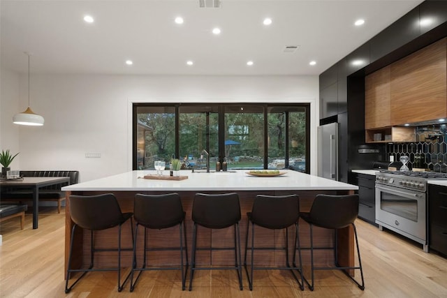 11420 Rim Rock Trl, Austin, TX 78737 - kitchen featuring high end stainless steel range, modern cabinets, light countertops, dark cabinets, and recessed lighting