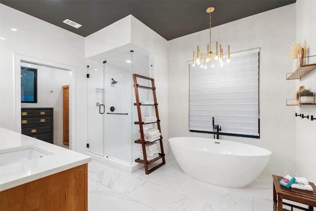 11420 Rim Rock Trl, Austin, TX 78737 - full bathroom featuring a freestanding tub, vanity, a shower stall, a chandelier, and marble finish floors
