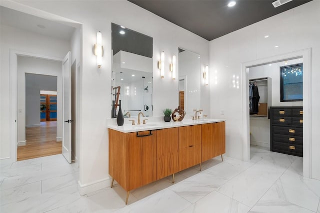 11420 Rim Rock Trl, Austin, TX 78737 - bathroom featuring marble finish flooring, double vanity, a walk in closet, and a shower