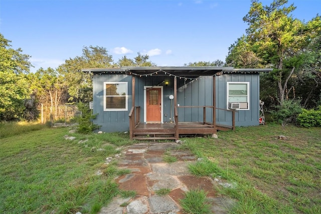 11420 Rim Rock Trl, Austin, TX 78737 - view of front of house with board and batten siding, a front lawn, and cooling unit