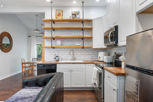 11420 Rim Rock Trl, Austin, TX 78737 - kitchen with butcher block counters, stainless steel appliances, backsplash, white cabinetry, and dark wood-style floors
