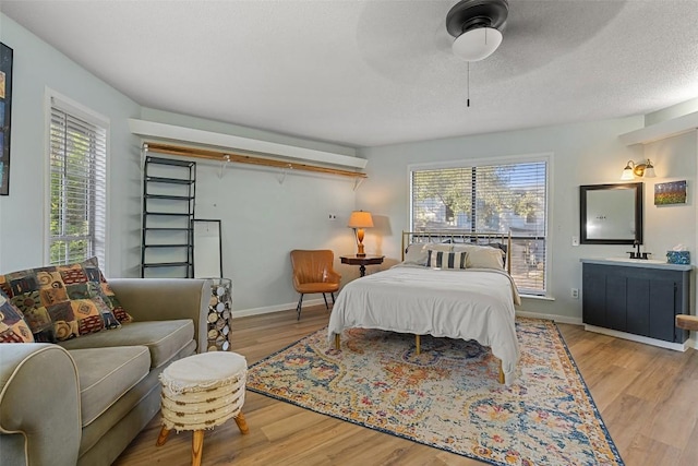 11420 Rim Rock Trl, Austin, TX 78737 - bedroom featuring multiple windows and wood finished floors