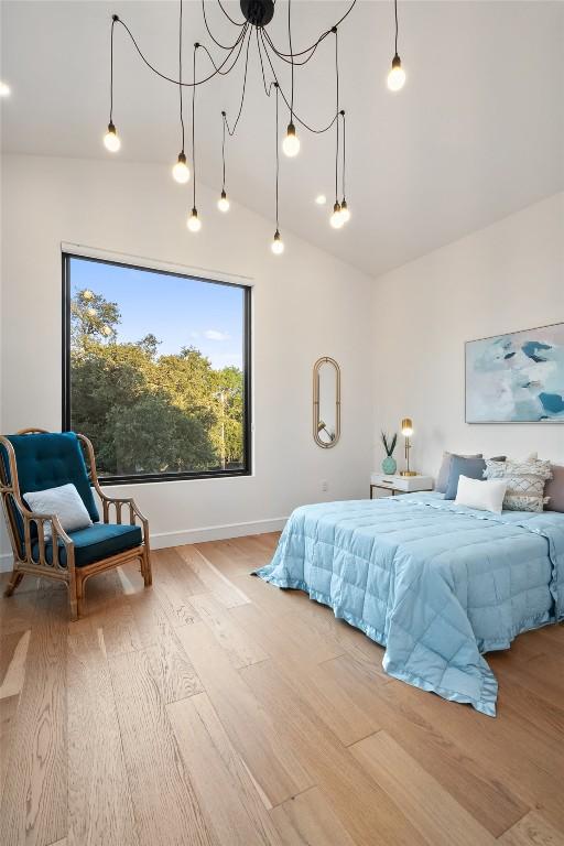 11420 Rim Rock Trl, Austin, TX 78737 - bedroom featuring wood finished floors and vaulted ceiling
