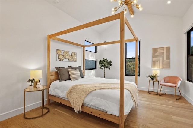 11420 Rim Rock Trl, Austin, TX 78737 - bedroom featuring vaulted ceiling, a chandelier, and wood finished floors