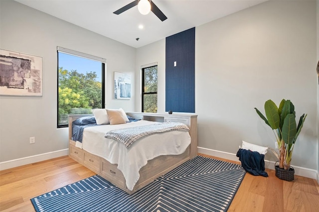 11420 Rim Rock Trl, Austin, TX 78737 - bedroom with wood finished floors, multiple windows, and a ceiling fan
