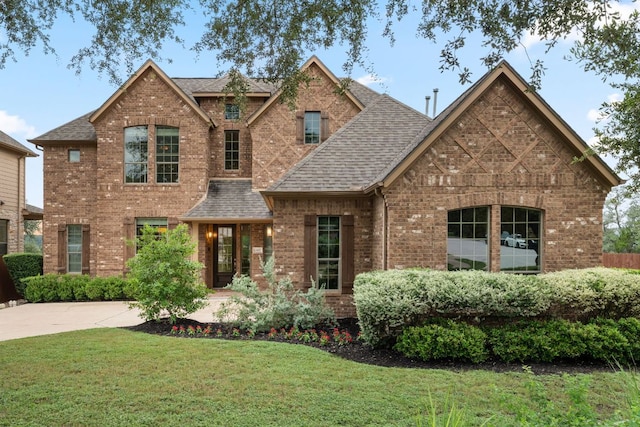 12417 Mediterra Pl, Austin, TX 78732 - view of front of property featuring roof with shingles, brick siding, and a front yard
