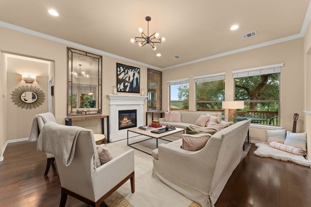 12417 Mediterra Pl, Austin, TX 78732 - living room featuring light wood-style floors, a chandelier, a glass covered fireplace, recessed lighting, and ornamental molding