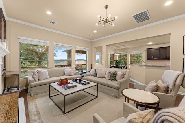 12417 Mediterra Pl, Austin, TX 78732 - living room featuring ornamental molding, a chandelier, recessed lighting, and wood finished floors
