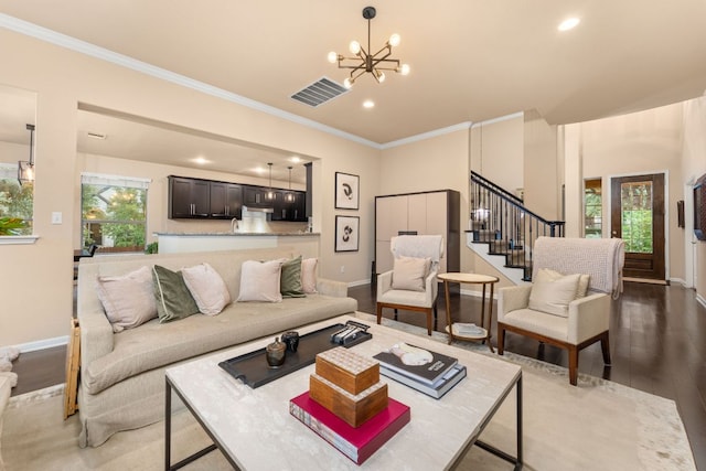 12417 Mediterra Pl, Austin, TX 78732 - living room featuring ornamental molding, stairway, recessed lighting, a chandelier, and wood finished floors