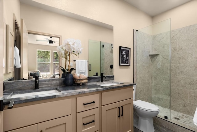 417 S Blanco St, Lockhart, TX 78644 - bathroom with double vanity, tiled shower, and a ceiling fan