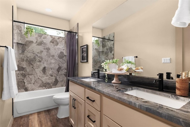 417 S Blanco St, Lockhart, TX 78644 - full bathroom with double vanity, shower / bath combination with curtain, and wood finished floors