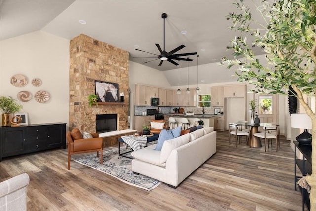 417 S Blanco St, Lockhart, TX 78644 - living room featuring ceiling fan, light wood-style floors, high vaulted ceiling, and a fireplace