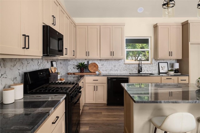 417 S Blanco St, Lockhart, TX 78644 - kitchen with black appliances, dark wood-style floors, dark stone counters, and tasteful backsplash