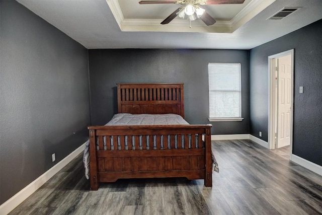 742 Annika Way, Bastrop, TX 78602 - bedroom featuring a raised ceiling, wood finished floors, ornamental molding, a ceiling fan, and a textured wall