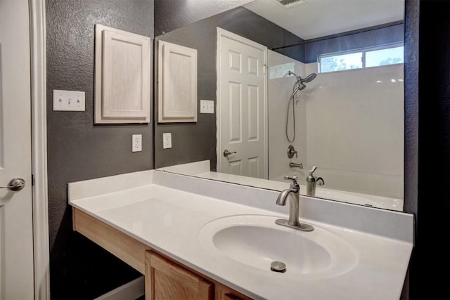 742 Annika Way, Bastrop, TX 78602 - full bath featuring a textured wall, vanity, and bathing tub / shower combination