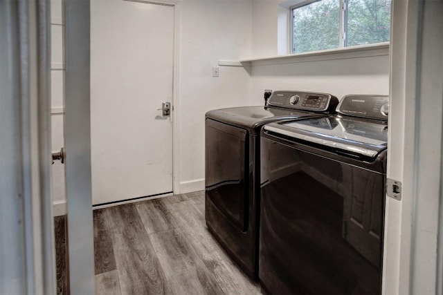 742 Annika Way, Bastrop, TX 78602 - laundry room with washing machine and dryer and wood finished floors