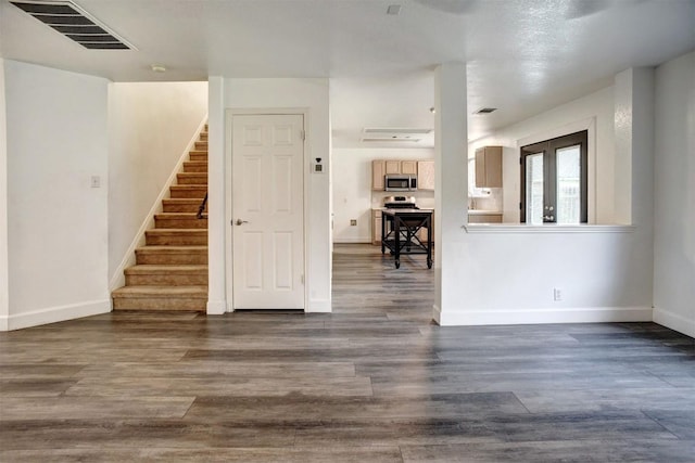 742 Annika Way, Bastrop, TX 78602 - unfurnished living room featuring stairs and dark wood finished floors