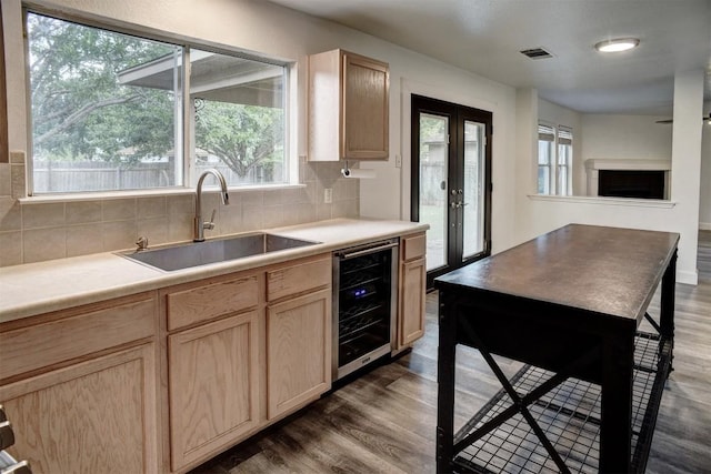 742 Annika Way, Bastrop, TX 78602 - kitchen featuring wine cooler, light brown cabinets, dark wood-style floors, and backsplash
