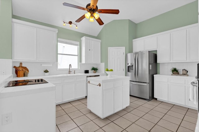 207 Golf Crest Ln, Lakeway, TX 78734 - kitchen featuring stainless steel fridge with ice dispenser, black electric cooktop, tasteful backsplash, lofted ceiling, and a ceiling fan
