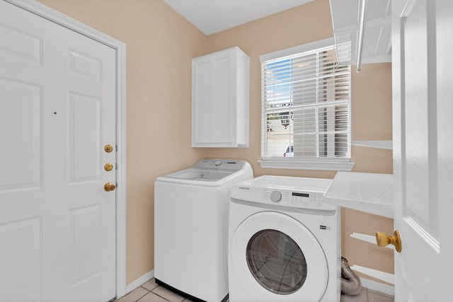 207 Golf Crest Ln, Lakeway, TX 78734 - laundry area featuring washing machine and dryer, cabinet space, and light tile patterned flooring