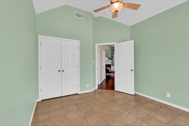 207 Golf Crest Ln, Lakeway, TX 78734 - unfurnished bedroom with high vaulted ceiling, a closet, light tile patterned floors, and a ceiling fan