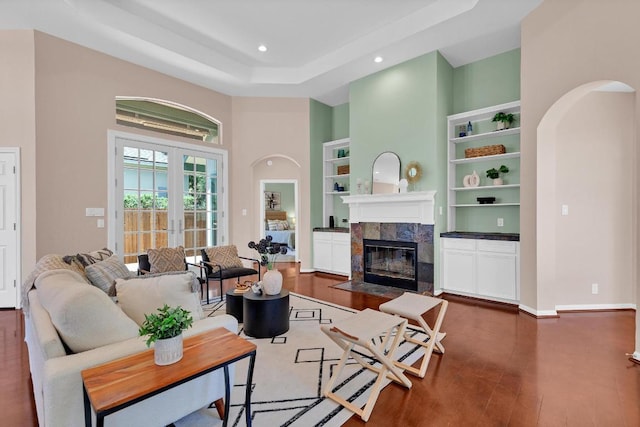 207 Golf Crest Ln, Lakeway, TX 78734 - living area featuring a high ceiling, a fireplace, arched walkways, wood finished floors, and built in features