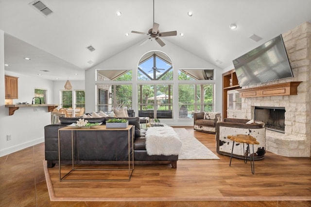 9 Heatherbloom Ln, The Hills, TX 78738 - living area with ceiling fan, a stone fireplace, wood finished floors, recessed lighting, and built in shelves