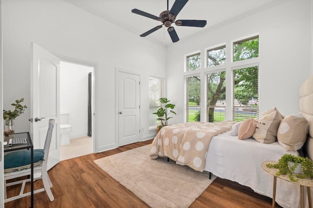 9 Heatherbloom Ln, The Hills, TX 78738 - bedroom with wood finished floors, a towering ceiling, ensuite bathroom, and a ceiling fan