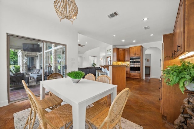 9 Heatherbloom Ln, The Hills, TX 78738 - dining area featuring recessed lighting, arched walkways, finished concrete flooring, vaulted ceiling, and a chandelier