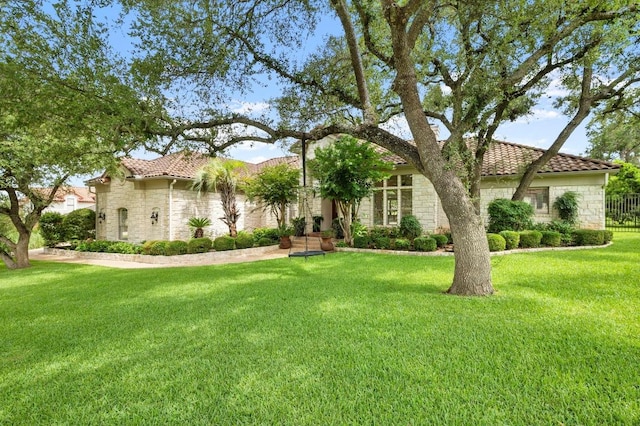 9 Heatherbloom Ln, The Hills, TX 78738 - mediterranean / spanish home with stone siding, a tile roof, and a front yard