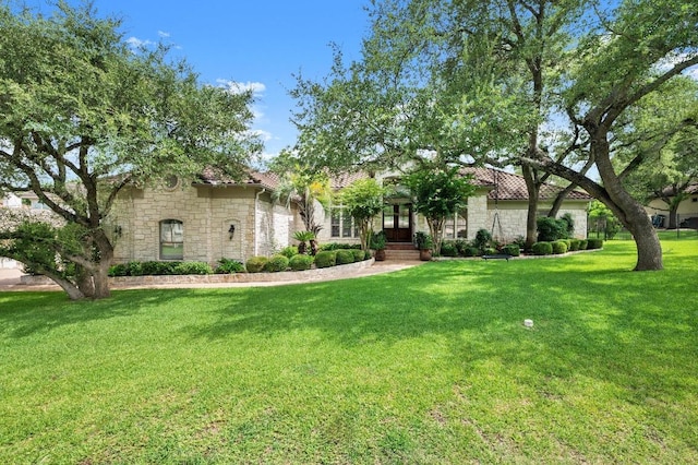 9 Heatherbloom Ln, The Hills, TX 78738 - view of front of property featuring stone siding, a front lawn, and a tile roof