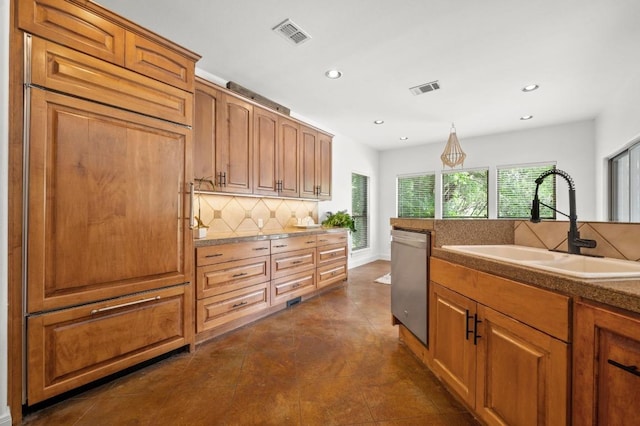 9 Heatherbloom Ln, The Hills, TX 78738 - kitchen featuring stainless steel dishwasher, recessed lighting, decorative backsplash, brown cabinets, and hanging light fixtures
