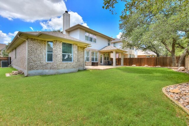 1108 Ritter Dr, Cedar Park, TX 78613 - rear view of house with a chimney, a patio area, a fenced backyard, and brick siding