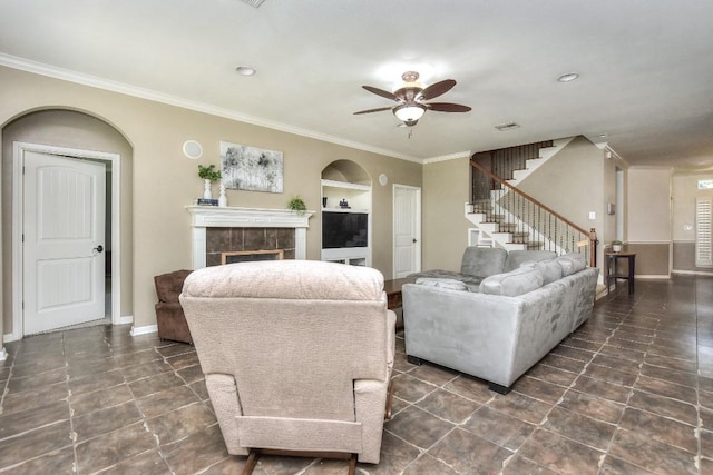 1108 Ritter Dr, Cedar Park, TX 78613 - tiled living area featuring ceiling fan, stairs, crown molding, a tiled fireplace, and built in features