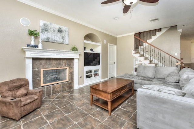 1108 Ritter Dr, Cedar Park, TX 78613 - living room featuring a ceiling fan, ornamental molding, stairway, tile patterned flooring, and a fireplace