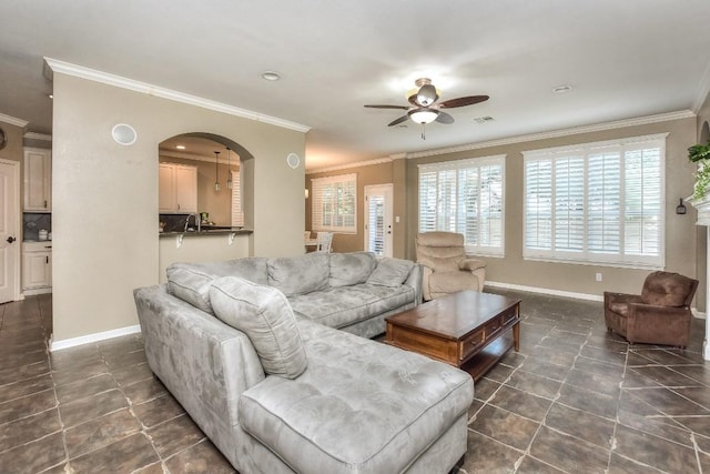 1108 Ritter Dr, Cedar Park, TX 78613 - living room with a ceiling fan, ornamental molding, arched walkways, dark tile patterned flooring, and recessed lighting