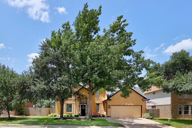 7900 Monona Ave, Austin, TX 78717 - view of front of property featuring a garage, concrete driveway, and brick siding
