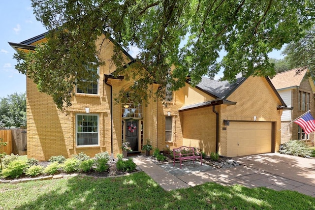 7900 Monona Ave, Austin, TX 78717 - view of front of home with a garage, brick siding, and driveway