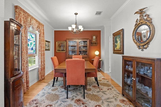 7900 Monona Ave, Austin, TX 78717 - dining area with a chandelier, light wood-style flooring, and ornamental molding